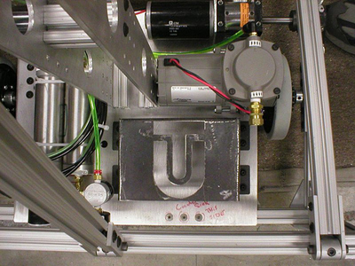 image of battery bracket attached to robot, with custom carved letters T U showing